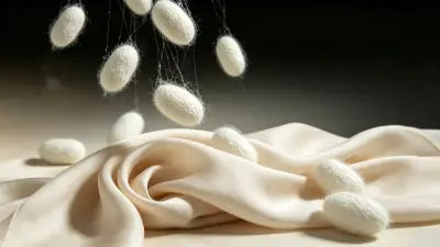 Comparison of 14 momme and 18 momme silk scarves showing difference in weight and drape